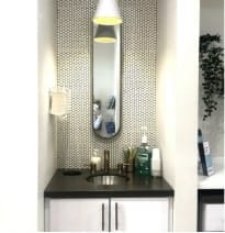 Modern dental office sink area with a mirror, soap, mouthwash, and stylish backsplash